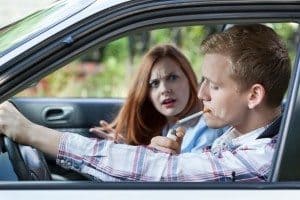 Woman mad at man for smoking cigarette in car